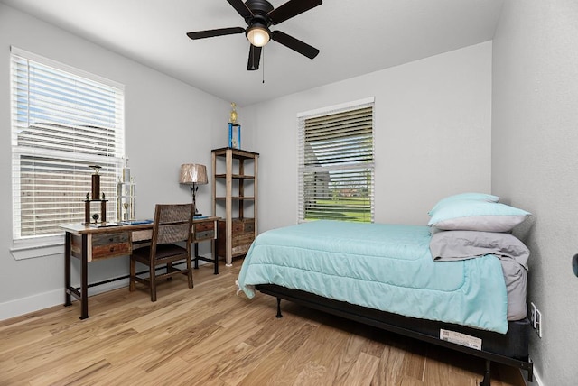 110 Les Ln, Smithville, TX 78957 - bedroom with light wood-style floors, multiple windows, and ceiling fan