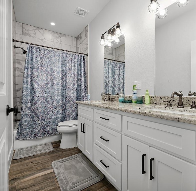 110 Les Ln, Smithville, TX 78957 - full bath with double vanity, shower / tub combo with curtain, and wood finished floors