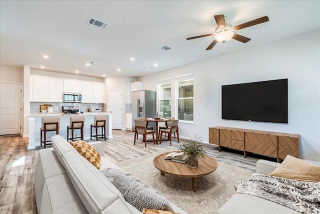 221 Delaware Mountains Ter, Dripping Springs, TX 78620 - living room with light wood-type flooring, a ceiling fan, and recessed lighting