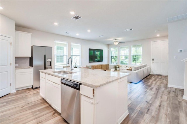 221 Delaware Mountains Ter, Dripping Springs, TX 78620 - kitchen with stainless steel appliances, recessed lighting, light wood-style floors, and light stone countertops