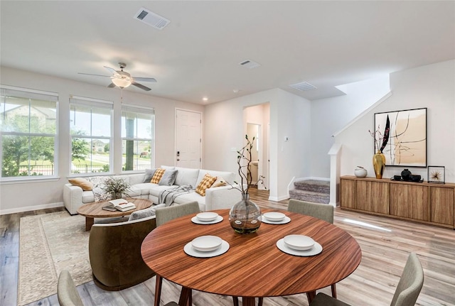 221 Delaware Mountains Ter, Dripping Springs, TX 78620 - living area with light wood finished floors, a ceiling fan, and stairs