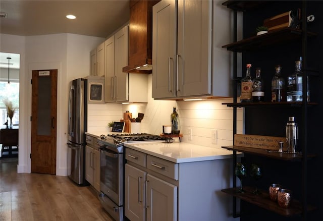 1654 Belvedere Pl, Round Rock, TX 78665 - kitchen featuring stainless steel appliances, light countertops, light wood-type flooring, gray cabinets, and recessed lighting