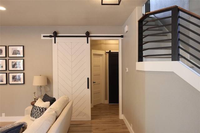 1654 Belvedere Pl, Round Rock, TX 78665 - corridor featuring wood finished floors, a barn door, and recessed lighting