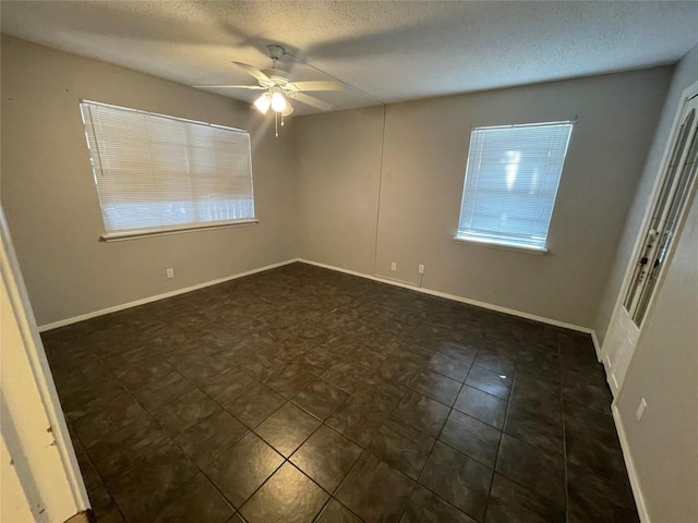 1206 Hi Stirrup Unit 300, Horseshoe Bay, TX 78657 - empty room featuring a ceiling fan and a textured ceiling