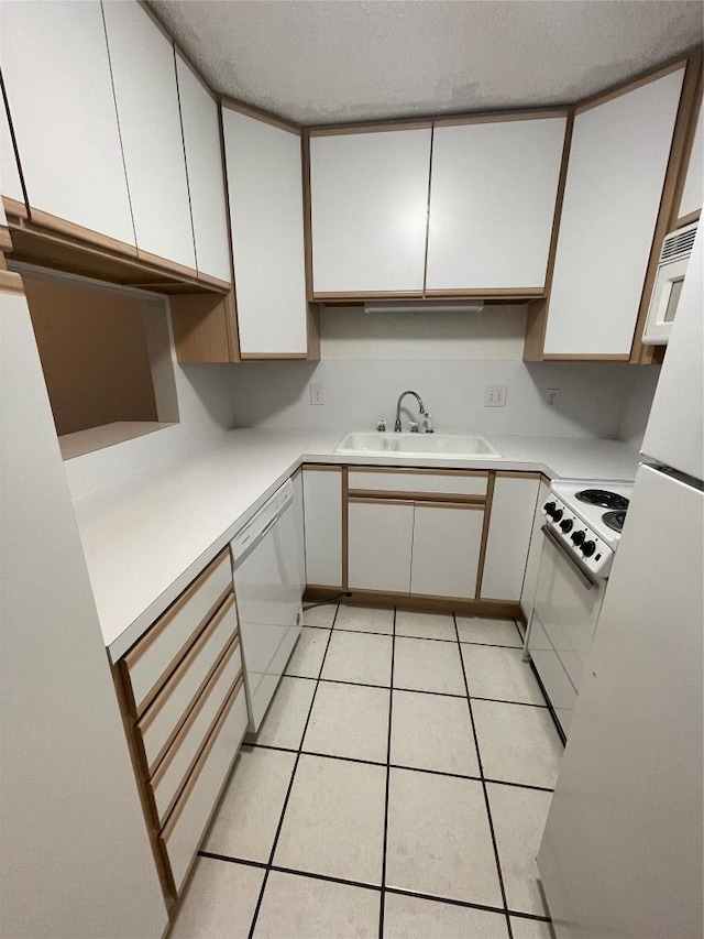 1206 Hi Stirrup Unit 300, Horseshoe Bay, TX 78657 - kitchen with white appliances, white cabinetry, light countertops, and a textured ceiling