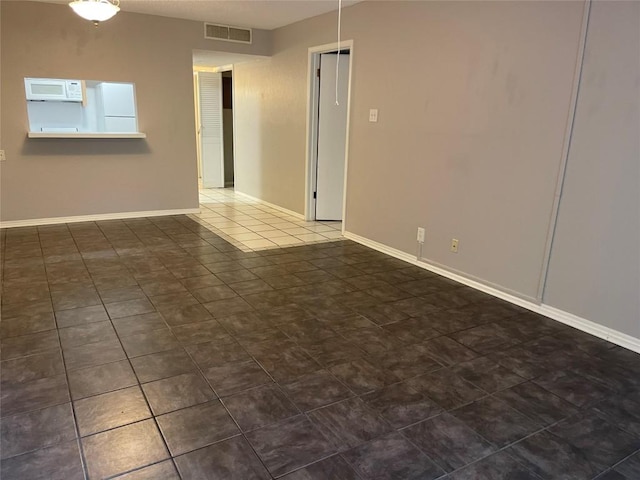 1206 Hi Stirrup Unit 300, Horseshoe Bay, TX 78657 - empty room featuring baseboards and dark tile patterned flooring