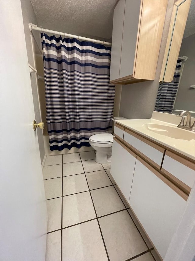 1206 Hi Stirrup Unit 300, Horseshoe Bay, TX 78657 - bathroom with vanity, tile patterned flooring, a textured ceiling, and a shower with curtain