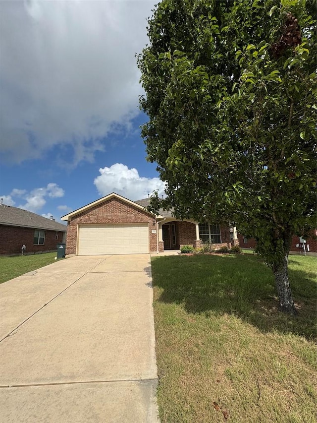 257 Firwood N, Kyle, TX 78640 - ranch-style house with brick siding, concrete driveway, a garage, and a front lawn