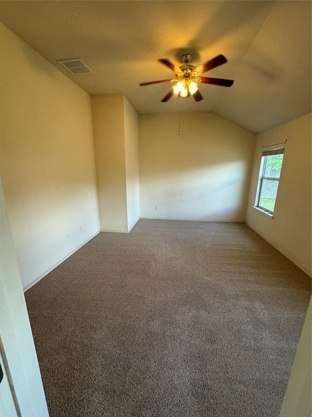 257 Firwood N, Kyle, TX 78640 - empty room with a ceiling fan, lofted ceiling, and carpet flooring