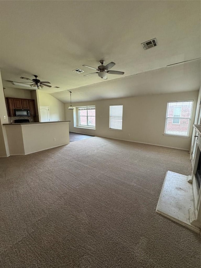 257 Firwood N, Kyle, TX 78640 - unfurnished living room with ceiling fan, carpet, a fireplace, and vaulted ceiling