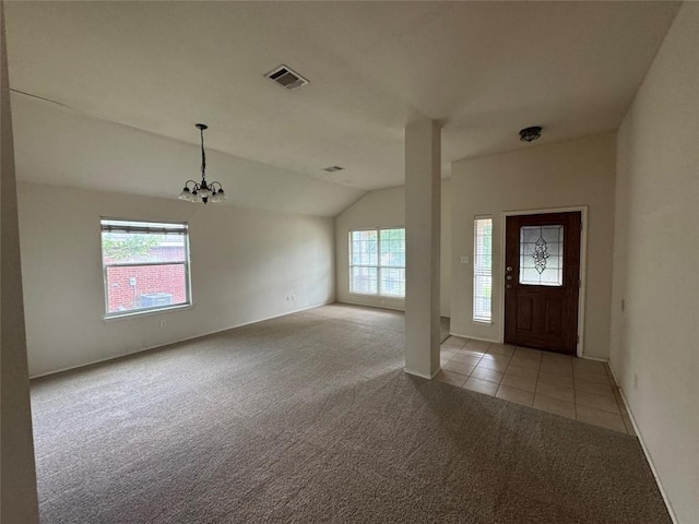257 Firwood N, Kyle, TX 78640 - entryway featuring light carpet, lofted ceiling, a chandelier, and light tile patterned floors