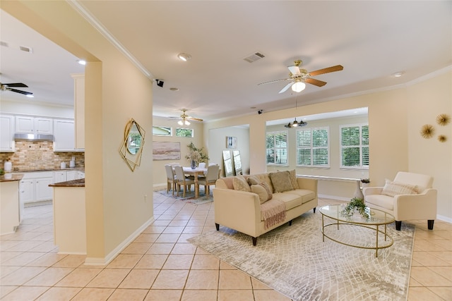 307 Dove Hollow Trl, Georgetown, TX 78633 - living room with ceiling fan, light tile patterned floors, ornamental molding, plenty of natural light, and recessed lighting