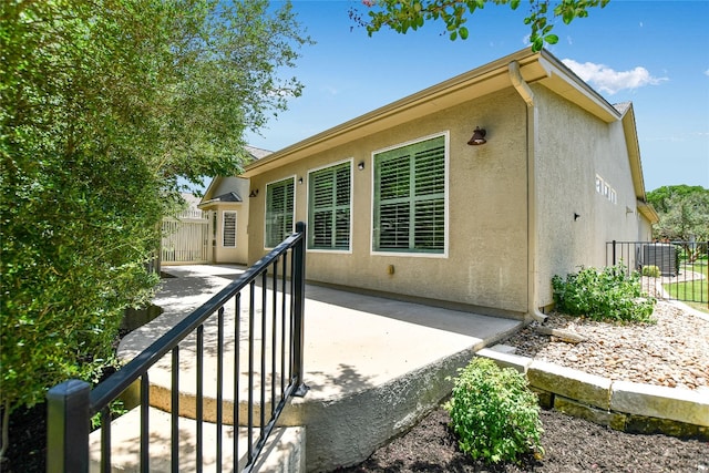 307 Dove Hollow Trl, Georgetown, TX 78633 - back of property with stucco siding and a patio