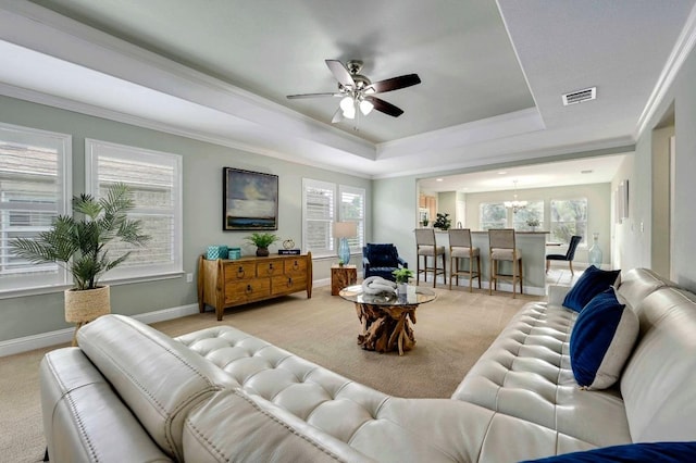 319 Salado Creek Ln, Georgetown, TX 78633 - living area with light carpet, a raised ceiling, ceiling fan, a chandelier, and crown molding