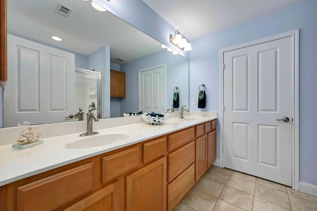 319 Salado Creek Ln, Georgetown, TX 78633 - bathroom with double vanity, a shower with shower door, and tile patterned floors