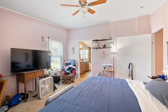 1231 Peach Creek Rd, Waelder, TX 78959 - bedroom featuring light colored carpet, a textured ceiling, ensuite bath, and ceiling fan