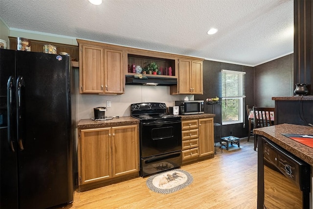 1231 Peach Creek Rd, Waelder, TX 78959 - kitchen featuring black appliances, extractor fan, light wood finished floors, a textured ceiling, and dark countertops