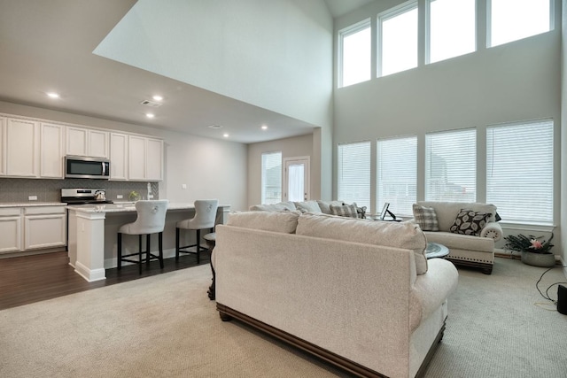 187 Glass Mountains Way, Dripping Springs, TX 78620 - carpeted living area featuring plenty of natural light, recessed lighting, and a towering ceiling