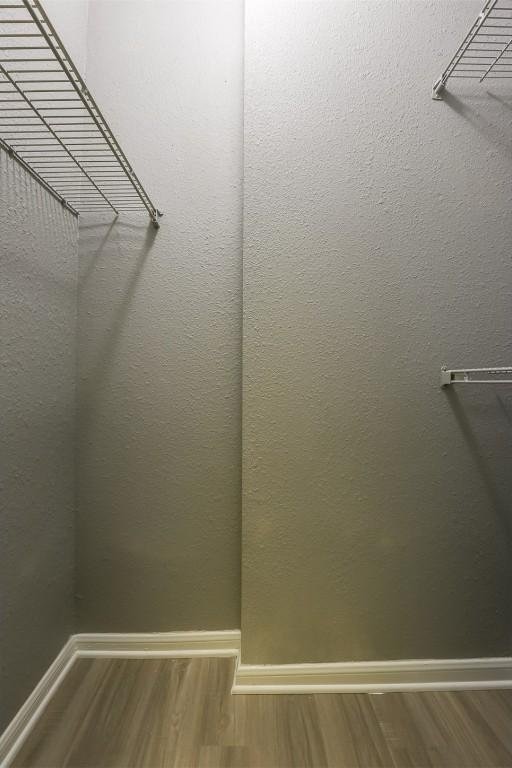 3111 Tom Green St Unit 105, Austin, TX 78705 - walk in closet featuring wood finished floors