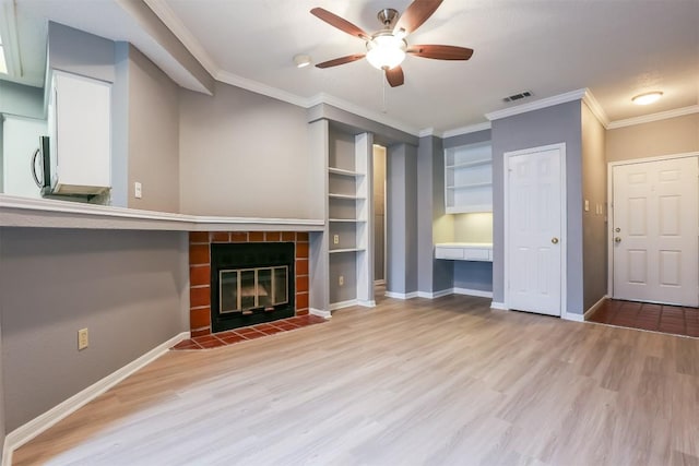 3111 Tom Green St Unit 105, Austin, TX 78705 - unfurnished living room featuring a ceiling fan, ornamental molding, wood finished floors, and a tiled fireplace