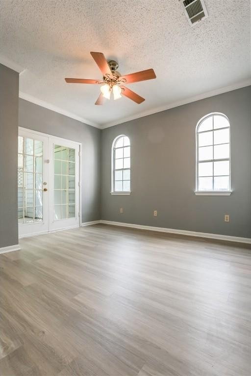 3111 Tom Green St Unit 105, Austin, TX 78705 - unfurnished room featuring ceiling fan, a textured ceiling, wood finished floors, and crown molding