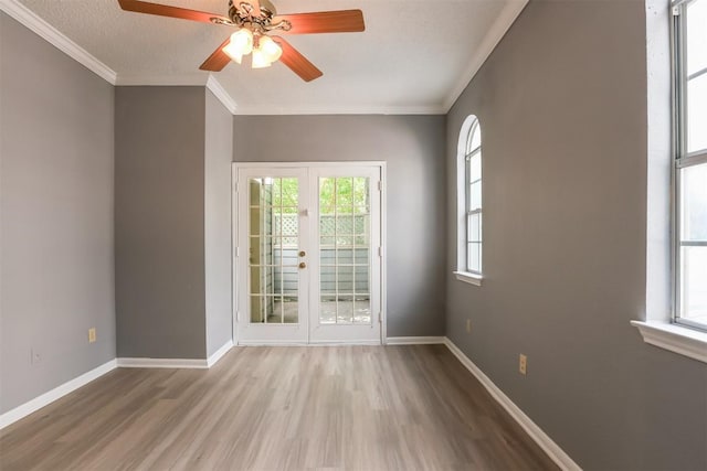 3111 Tom Green St Unit 105, Austin, TX 78705 - spare room featuring wood finished floors, plenty of natural light, ceiling fan, crown molding, and french doors