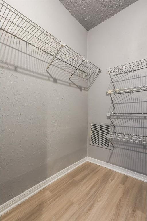 3111 Tom Green St Unit 105, Austin, TX 78705 - walk in closet featuring wood finished floors