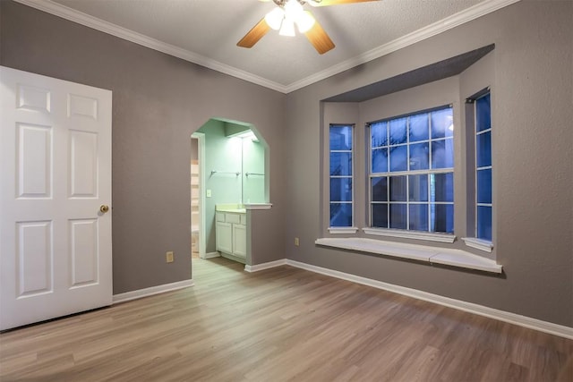 3111 Tom Green St Unit 105, Austin, TX 78705 - unfurnished room with ceiling fan, wood finished floors, arched walkways, and crown molding