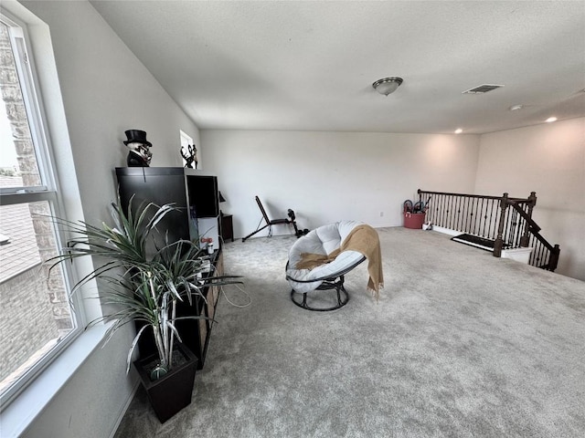 1121 Arbor Acres Loop, Leander, TX 78641 - living area with carpet flooring and an upstairs landing