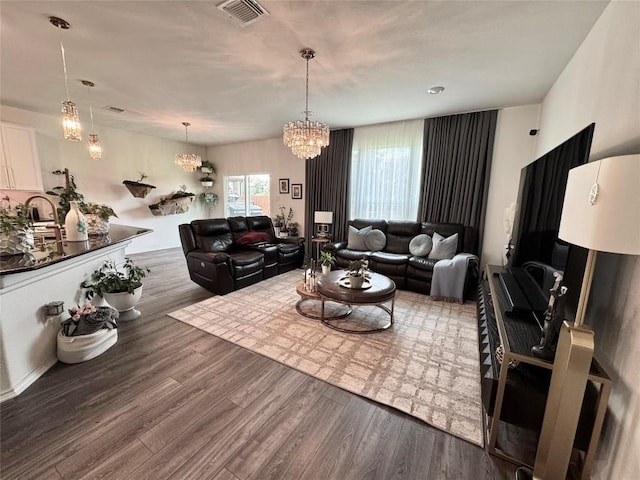 1121 Arbor Acres Loop, Leander, TX 78641 - living room featuring wood finished floors and a chandelier