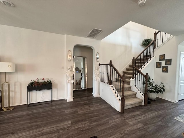1121 Arbor Acres Loop, Leander, TX 78641 - foyer entrance with arched walkways, wood finished floors, and stairs
