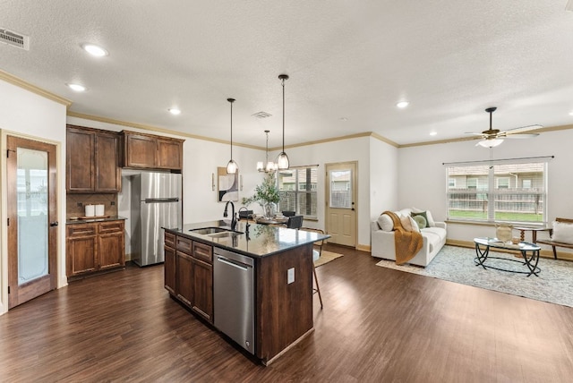 7606 Hickman St, Temple, TX 76502 - kitchen with appliances with stainless steel finishes, dark wood-style floors, open floor plan, plenty of natural light, and recessed lighting