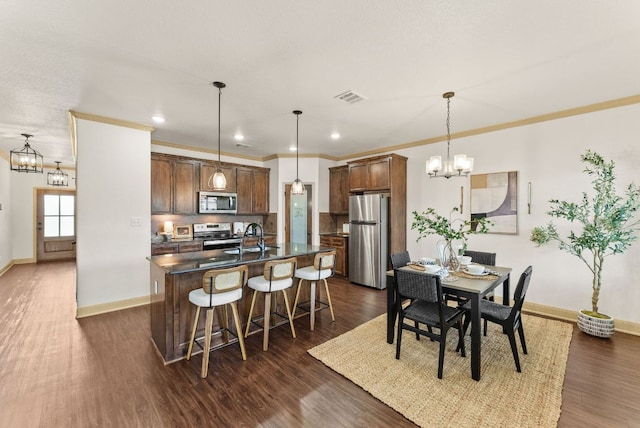 7606 Hickman St, Temple, TX 76502 - dining room with a chandelier, dark wood-style flooring, crown molding, and recessed lighting