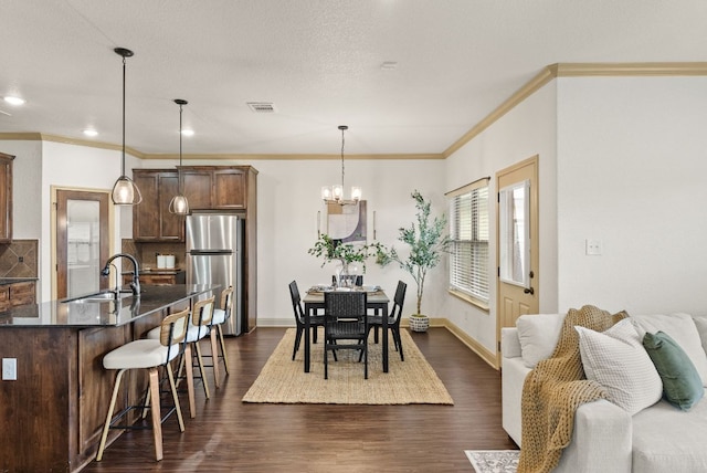 7606 Hickman St, Temple, TX 76502 - dining room featuring dark wood-style flooring, ornamental molding, a chandelier, and recessed lighting
