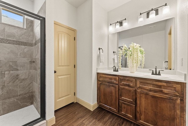 7606 Hickman St, Temple, TX 76502 - bathroom featuring a shower stall, wood finished floors, and double vanity