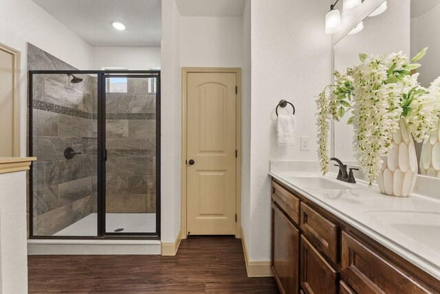 7606 Hickman St, Temple, TX 76502 - bathroom with a stall shower, double vanity, and wood finished floors