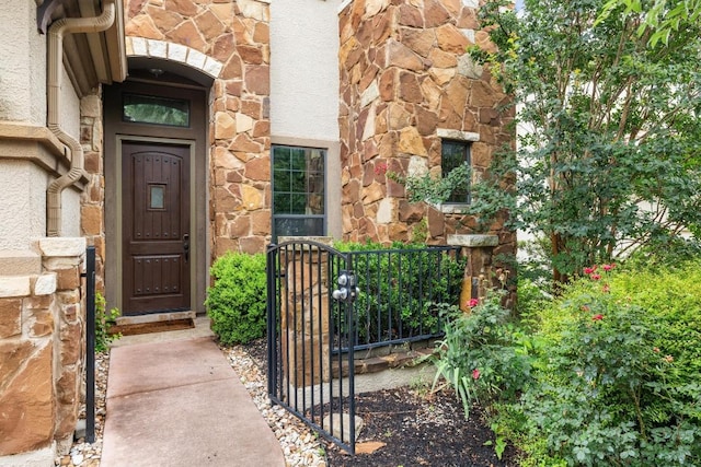 114 Reflection Bay Ct, Austin, TX 78738 - property entrance with stone siding and a gate