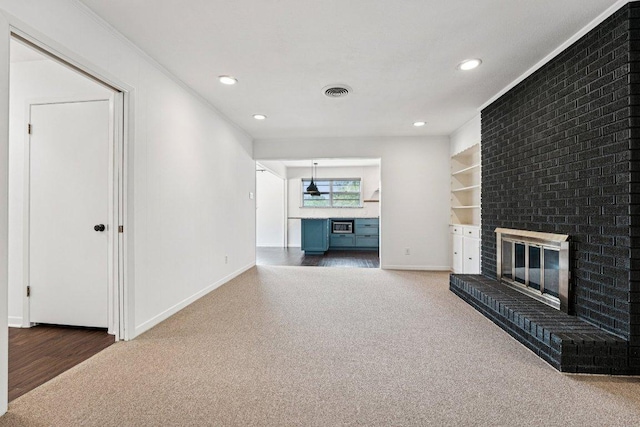 3806 Las Cienega Blvd, Temple, TX 76502 - unfurnished living room featuring a brick fireplace, ornamental molding, recessed lighting, and carpet flooring
