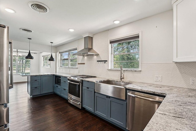3806 Las Cienega Blvd, Temple, TX 76502 - kitchen with appliances with stainless steel finishes, wall chimney range hood, dark wood-style flooring, light stone counters, and recessed lighting