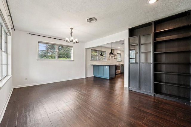 3806 Las Cienega Blvd, Temple, TX 76502 - unfurnished living room featuring a chandelier, dark wood-style flooring, and a textured ceiling