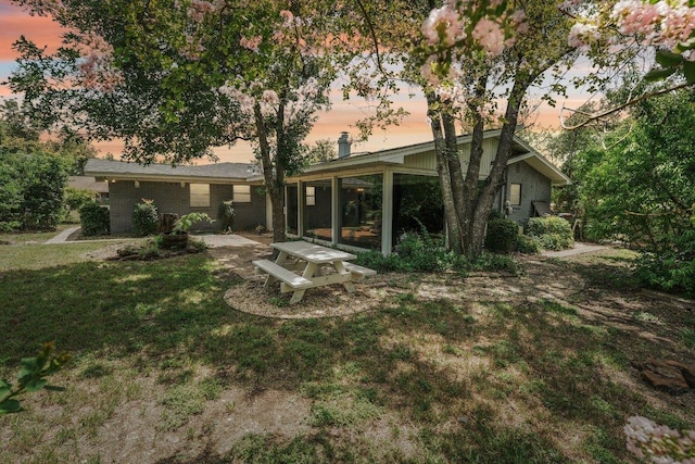 3806 Las Cienega Blvd, Temple, TX 76502 - back of house at dusk featuring a yard