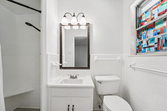 3806 Las Cienega Blvd, Temple, TX 76502 - bathroom with a tile shower, vanity, and a wainscoted wall