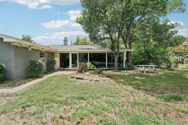 3806 Las Cienega Blvd, Temple, TX 76502 - rear view of property with brick siding, a yard, and a chimney