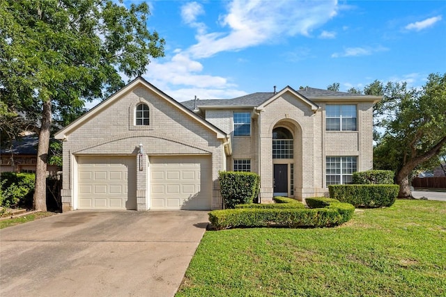 1217 Dove Cir, Cedar Park, TX 78613 - traditional-style house with concrete driveway, a garage, a front lawn, and brick siding