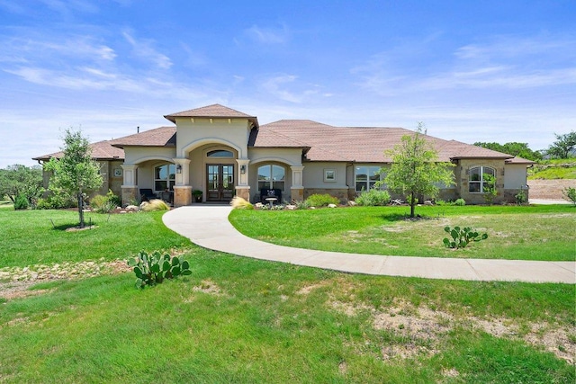 105 Clear Springs Ct, Marble Falls, TX 78654 - mediterranean / spanish-style house with french doors, stucco siding, and a front lawn