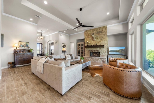 105 Clear Springs Ct, Marble Falls, TX 78654 - living room featuring a ceiling fan, ornamental molding, a fireplace, recessed lighting, and a high ceiling
