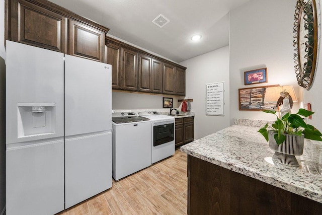105 Clear Springs Ct, Marble Falls, TX 78654 - washroom with cabinet space, washer and dryer, light wood finished floors, and recessed lighting