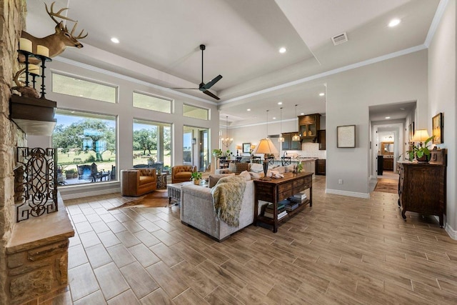 105 Clear Springs Ct, Marble Falls, TX 78654 - living area with a ceiling fan, light wood-style flooring, crown molding, a towering ceiling, and recessed lighting