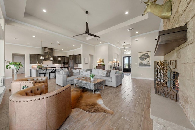105 Clear Springs Ct, Marble Falls, TX 78654 - living room featuring a raised ceiling, wood finish floors, recessed lighting, ceiling fan, and crown molding