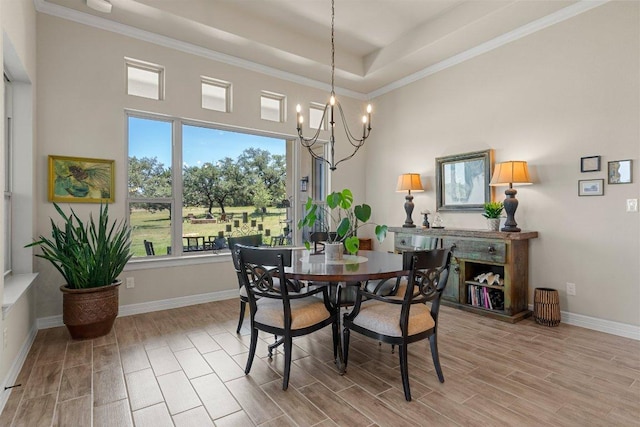 105 Clear Springs Ct, Marble Falls, TX 78654 - dining space with wood tiled floors, a chandelier, a raised ceiling, crown molding, and a towering ceiling